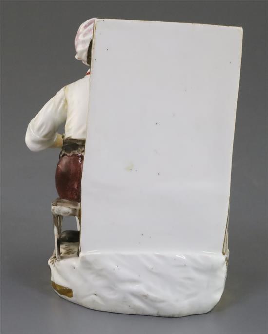 A Rockingham porcelain figure of a seated cobbler, c.1830, H.14cm, left arm re-stuck at shoulder